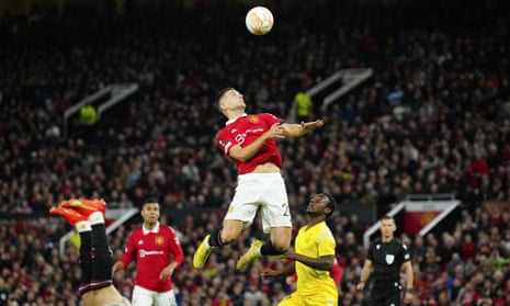 Manchester United's Diogo Dalot jumps for the ball.
