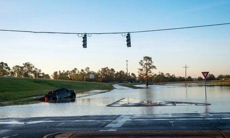 A submerged car is pictured on a flooded street after Hurricane Delta in October last year. ‘Climate change is something that is affecting this community,’ said the city’s Republican mayor.