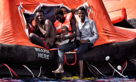 People await rescue in a drifting boat in the Mediterranean last year