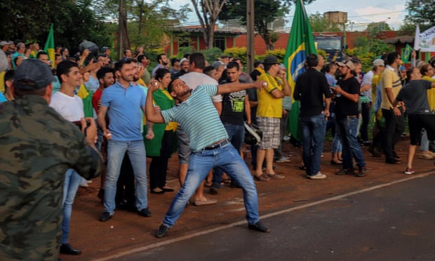 An opponent of former Brazilian president Luiz Inacio Lula da Silva throws stones during a demonstration.