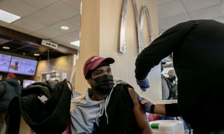 A man receives his Covid booster at a McDonald’s in Chicago.