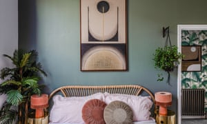 The master bedroom, showing the top of the bed and green walls, and a view to the hall with palm jungle wallpaper