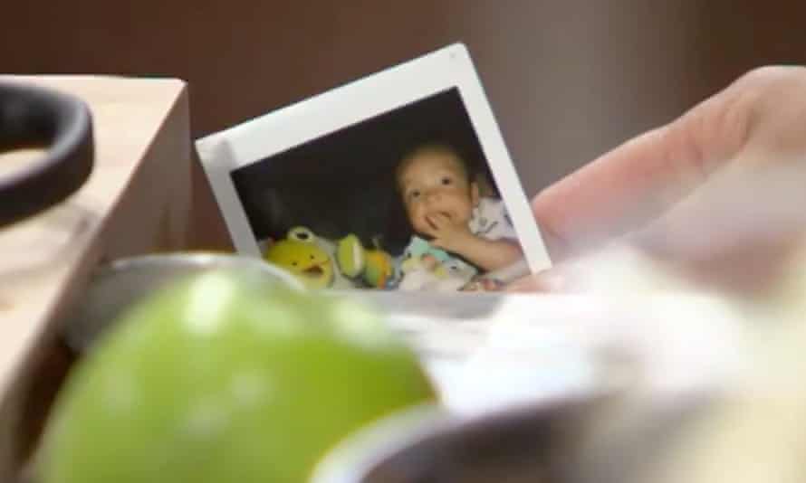 An apple and a polaroid of a baby