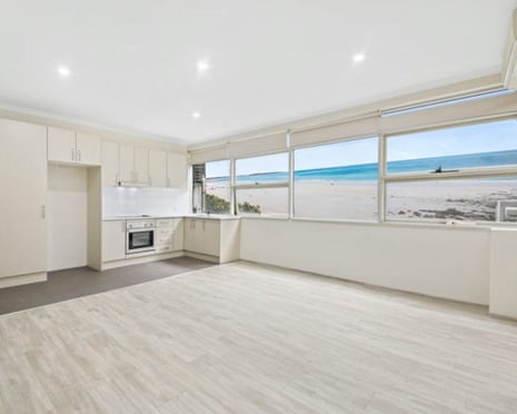 An apartment kitchen with what appears to be Bondi beach out the kitchen window but is actually a mural on an outdoor wall