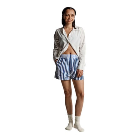 Model wears striped boxer shorts.