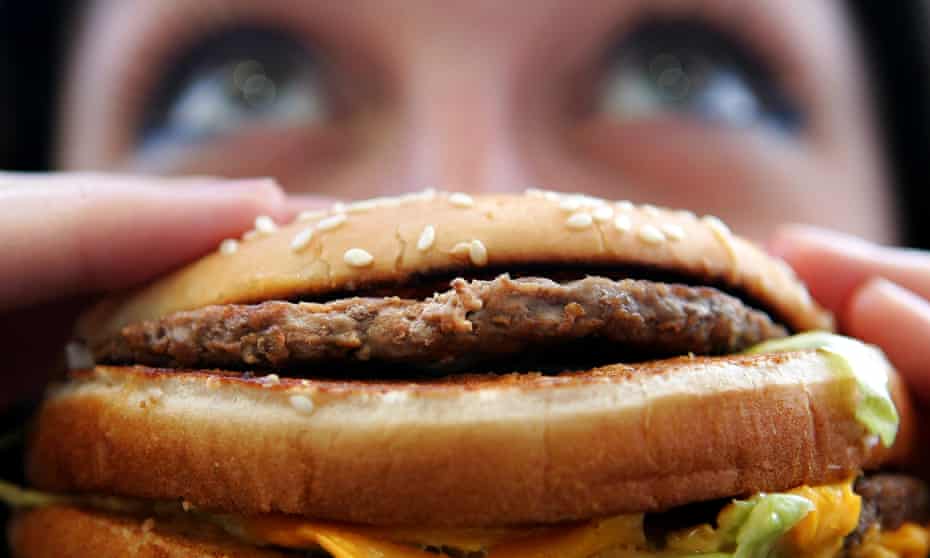 Person eating fast food burger