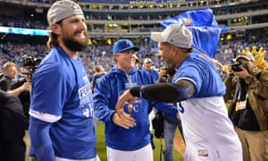 Royals
manager Ned Yost (middle) and catcher Salvador Perez (right)
celebrate after defeating the Blue Jays.