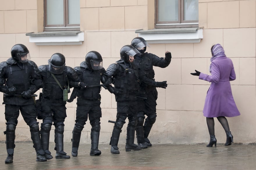 A woman argues with Belarus police officers blocking a street during an opposition rally in Minsk, Belarus, on 25 March, 2017