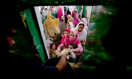 A Pakistani woman receives free food
