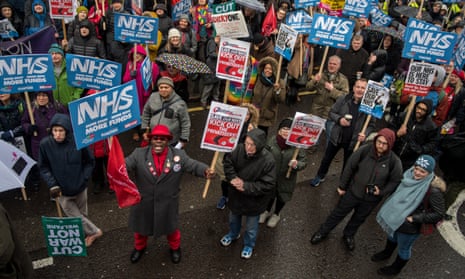 Protesters march in London against the NHS financial crisis last February.