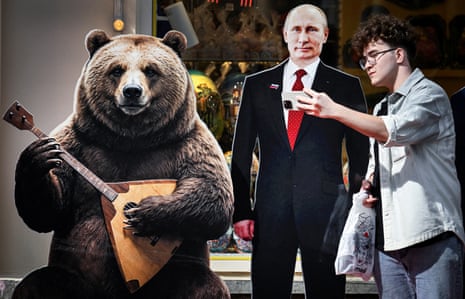 A man makes a selfie photo with a cardboard image depicting Russian President Vladimir Putin at the touristic Arbat street in downtown Moscow on August 24, 2026. There is also a cut out of a bear playing a stringed instrument