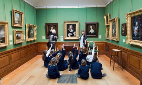 Schoolchildren raising their hands on educational school trip to The Dulwich Picture Gallery