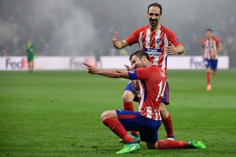 Atletico Madrid’s midfielder Gabi celebrates past Atletico Madrid’s Diego Godin after scoring
