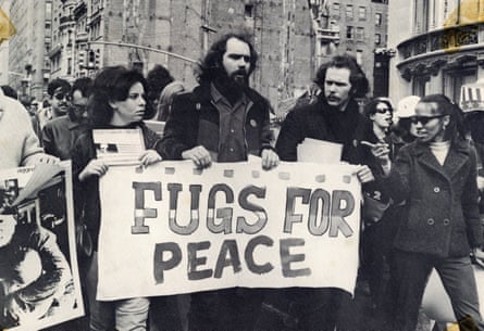 Sanders (above “for”) and bandmate Ken Weaver protesting against the Vietnam war in 1967.