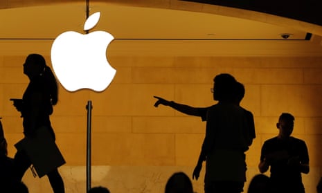 Customers walk past an Apple logo inside Grand Central Station in New York.