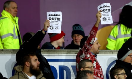 Swansea fans hold up poster in protest against the chairman, Huw Jenkins