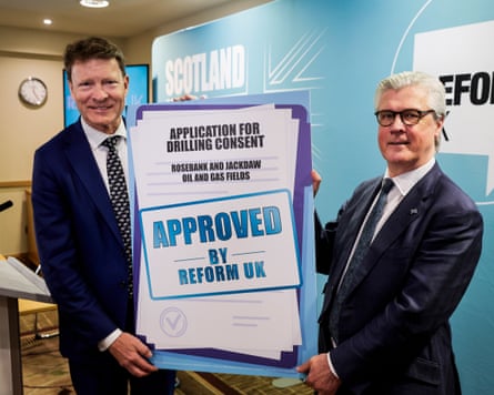 Tice and Orford hold up a fake sign that says Rosebank oilfield has been approved for drilling consent by Reform UK