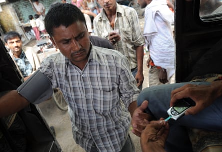 A man has his blood sugar checked at a mobile clinic outside the Geeta Colony area of Delhi. Cases of diabetes and hypertension have been rising rapidly among slum dwellers in India.