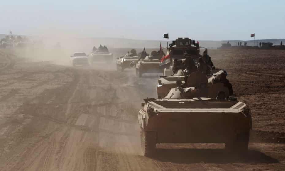 Iraqi military vehicles advance towards the village of Sheikh Younis, south of Mosul