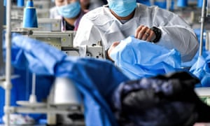 Workers make protective suits at a factory of a medical equipment maker in Urumqi, Xinjiang Uighur Autonomous Region, China in January