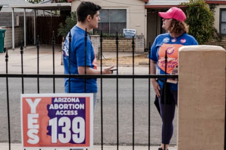 a man and woman in front of a sign