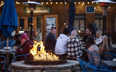 People sit near a fire pit in the resort town of South Lake Tahoe.
