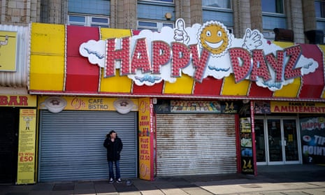 A man stands outside a closed cafe in Blackpool