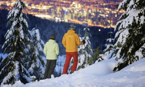 Skiers at Cypress mountain enjoy the view over Vancouver.