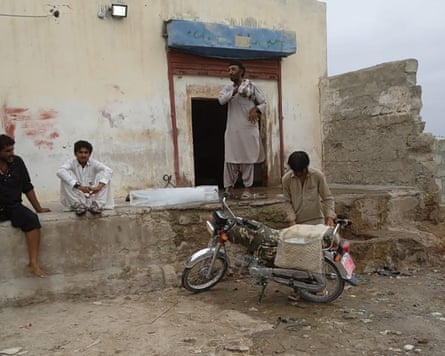 Taimoor with his moped loaded with ice outside the ice factory.