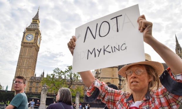 An anti-monarchy protester outside parliament before the arrival of King Charles III.