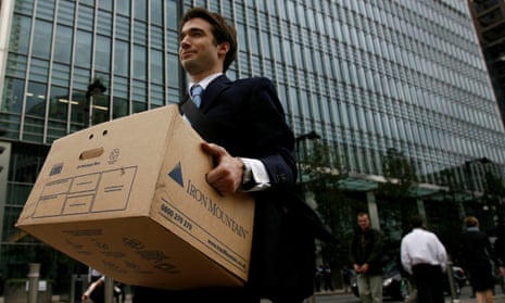 A worker carries a box out of the US investment bank Lehman Brothers offices at Canary Wharf, east London in September 2008.
