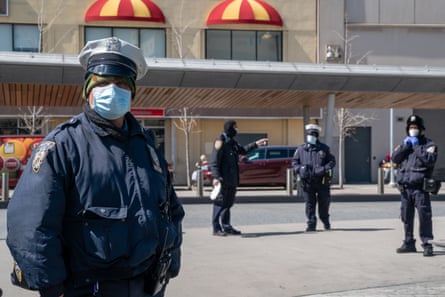 New York Police Department (NYPD) officers wear protective masks at the Fordham bus hub in the Bronx borough of New York, U.S., on Thursday, April 2, 2020. In four months, the new coronavirus infected more than 1 million people and killed more than 51,000. The U.S. accounts for a quarter of the cases.