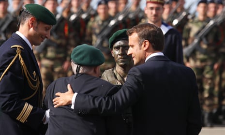 French President Emmanuel Macron, right, hugs French war veteran Leon Gautier a ceremony to pay homage to the Kieffer commando, Thursday, June 6, 2019 in Colleville-Montgomery, Normandy. T
