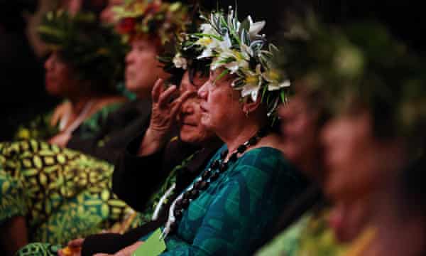 Guests listen as Jacinda Ardern apologises