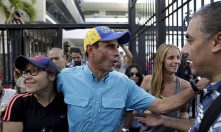 Venezuelan opposition leader Henrique Capriles greets supporters after casting his vote at a polling station in Caracas<br>