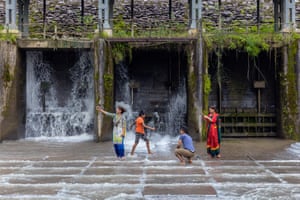 A family plays precariously in the spillway of Bidur’s hydroelectric dam. The canal above the dam provides both electricity and water supply to this Nepali town.