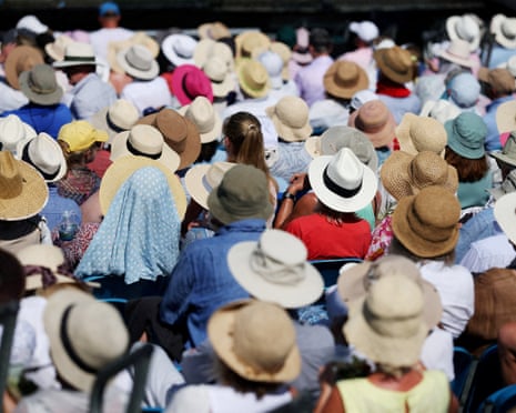 General view of tennis spectators in Eastbourne during the heatwave as they take cover under hats.