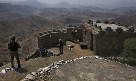 Pakistan troops stand guard at a hilltop post in the Khyber district