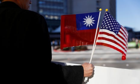 A demonstrator holds flags of Taiwan and the United States in support of Taiwanese President Tsai Ing-wen during her stopover in California.
