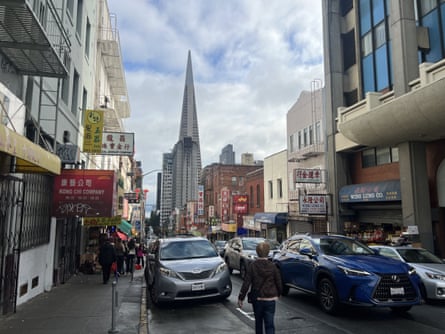 A busy street with a triangular building in the background.