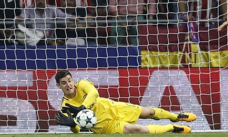 Chelsea goalkeeper Thibaut Courtois gets down smartly to make a save.