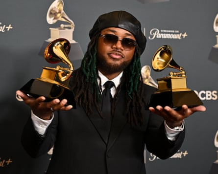 Thomas holds a Grammy in each hand