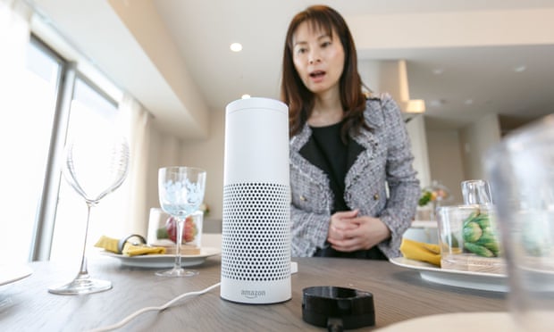 A woman using an Amazon smart speaker.