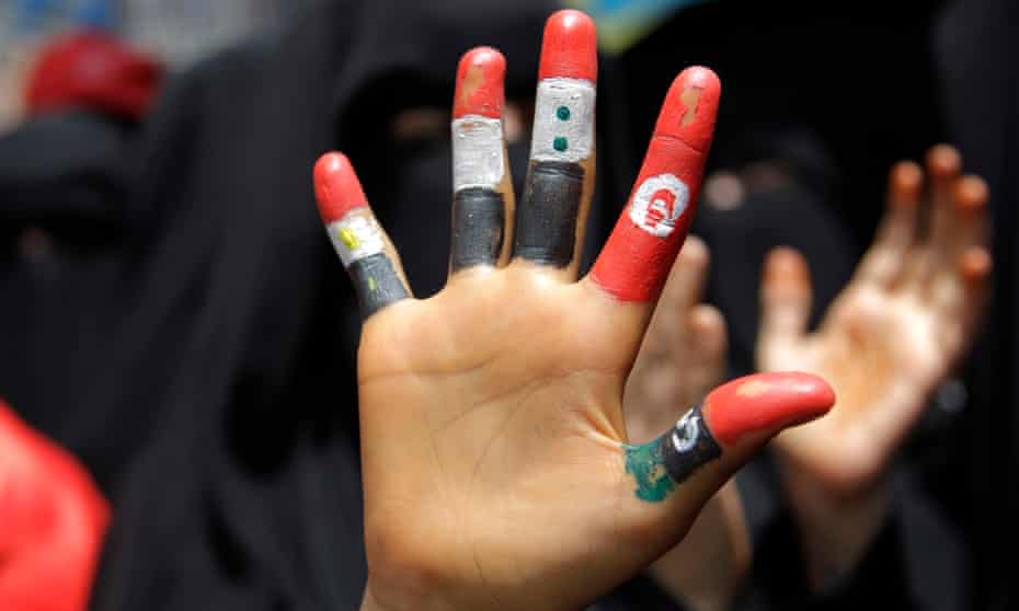 A girl’s fingers painted with the flags of Egypt, Yemen Syria, Tunisia and Libya during a demonstration in Taiz, Yemen, in June 2011. 