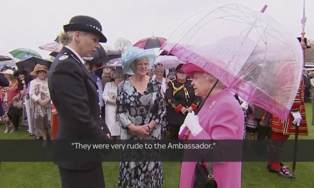 In image made from pool video, Queen Elizabeth II speaks with Metropolitan police commander Lucy D’Orsi in the garden of Buckingham Palace.