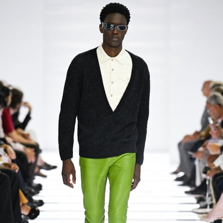 A model wearing a white shirt, black cardigan and lime green trousers