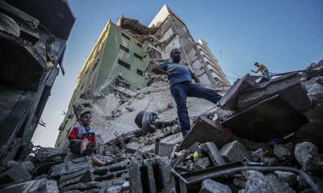 Palestinians amid ruined buildings in Gaza City on Wednesday