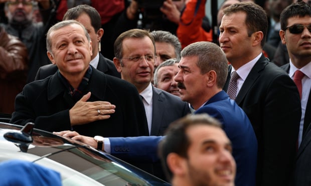 The Turkish president, Recep Tayyip Erdoğan, gestures to supporters