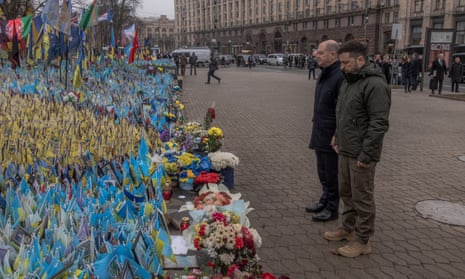 Volodymyr Zelenskyy and Olaf Scholz visit the makeshift memorial paying tribute to Ukrainian and foreign fighters at the independence square in Kyiv.
