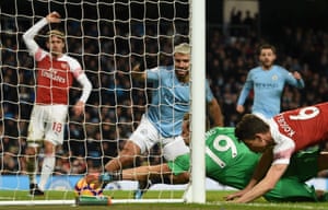 City’s Argentinian striker Sergio Agüero scored three times – the first inside the opening minute and the last inadvertently using his hand. This picture shows Arsenal’s players failing to prevent him sealing his hat-trick. City won 3-1.